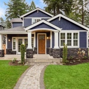 Front view of Home Exterior with lawn and brick walkway