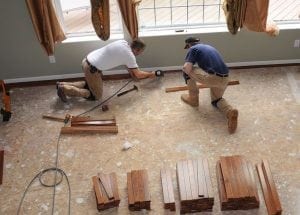 Men laying new hardwood flooring