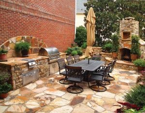 Beautful outdoor area to gather with family and friends with seating to dine, outdoor kitchen and fireplace