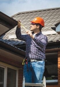 Contractor inspecting the roof of a home