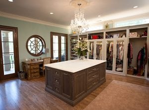 walk in closet, with a double door that opens to a deck