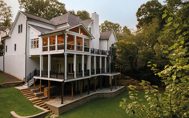 Multi-level luxury deck with spiral staircase and covered porch by Decks & More. Featured as a My Home Improvement 2026 Backyard Boss.