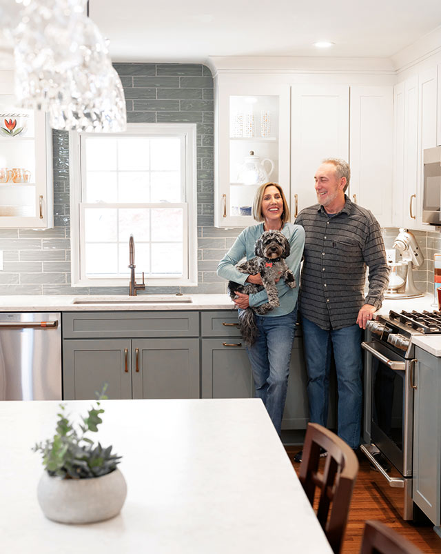 Patti and Mark Stevens standing in their renovated kitchen.
